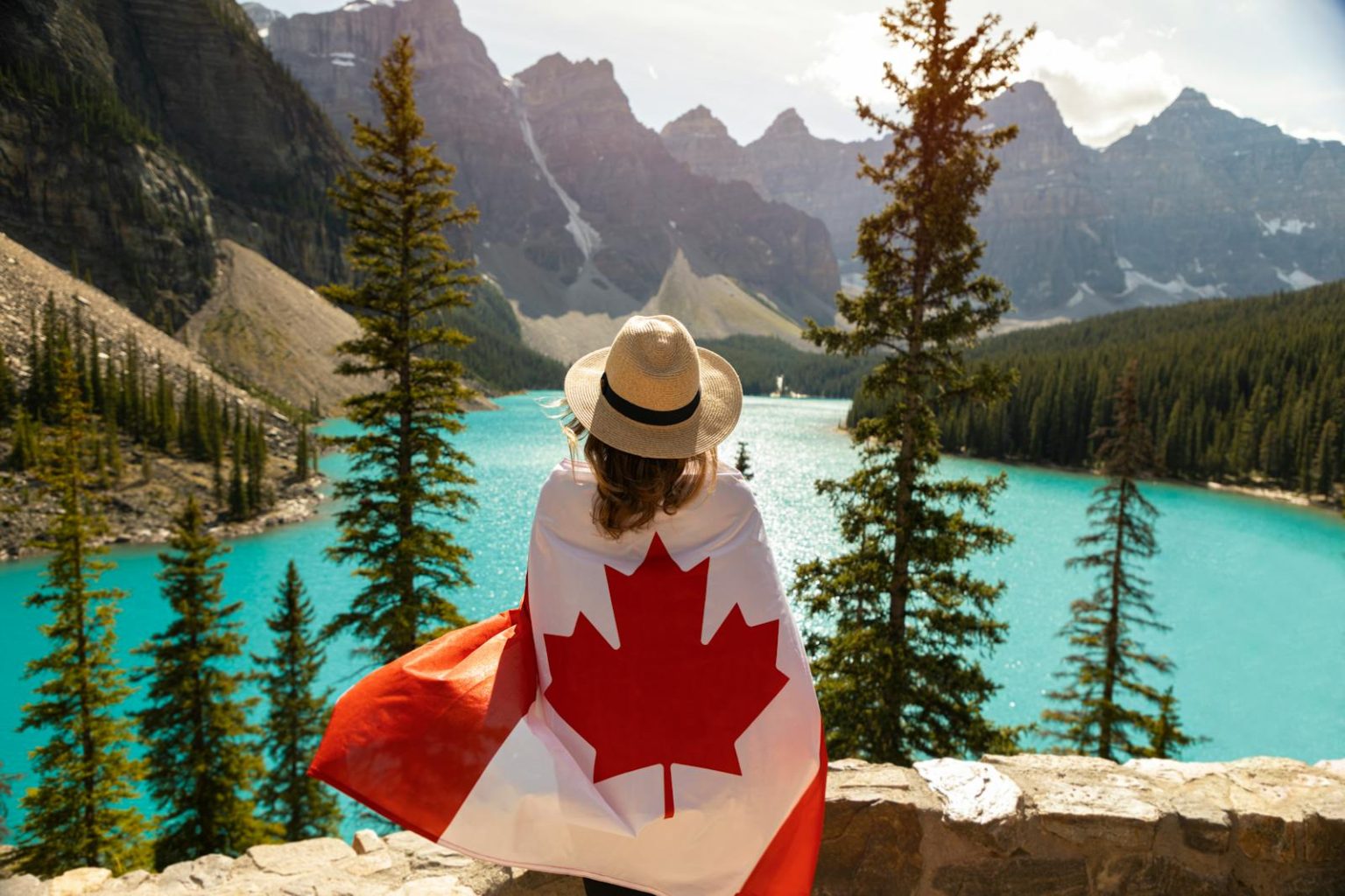 Explore the beauty of Moraine Lake in Alberta, Canada, with a stunning view and a Canadian flag.