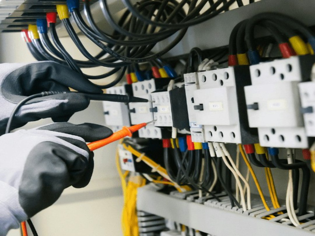 Electrician testing an electrical panel representing power and utility careers in Canada