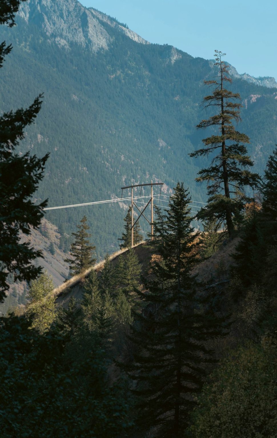 British Columbia In-Demand Careers: Jobs, Pay, Skills and Major Projects Power transmission lines crossing a forested mountain valley in British Columbia