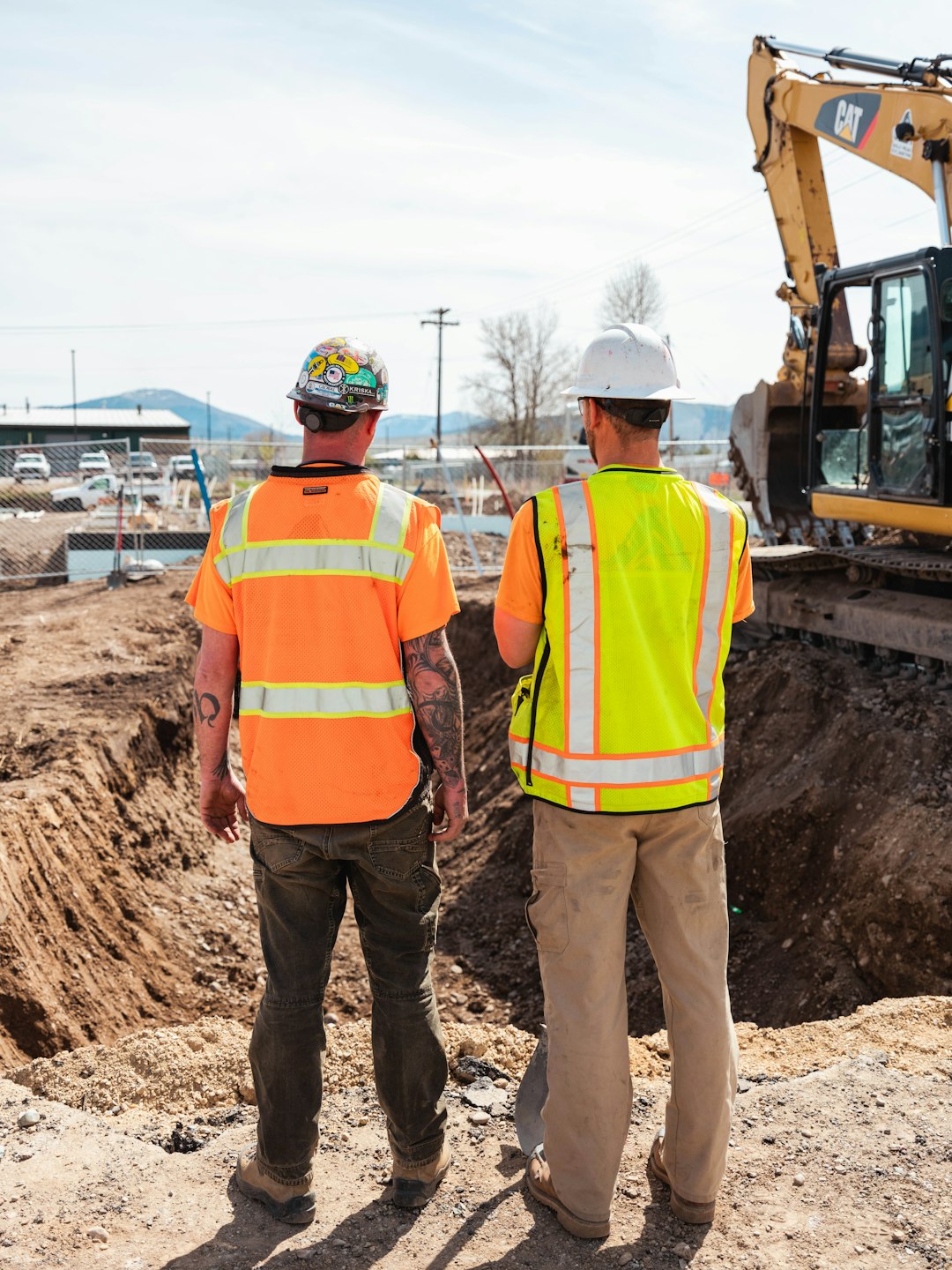 Workers in safety equipment at an industrial work site, illustrating mining and critical minerals careers