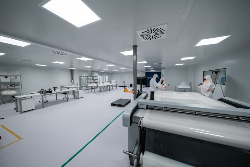 Bioprocess manufacturing workers inside a controlled cleanroom environment