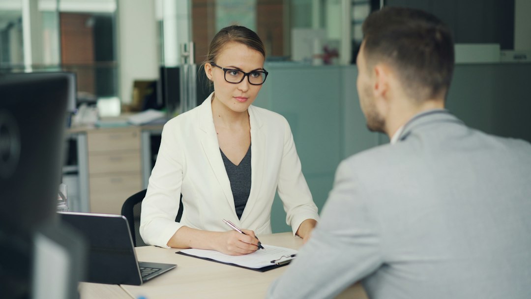 Candidate and interviewer discussing a job application in an office