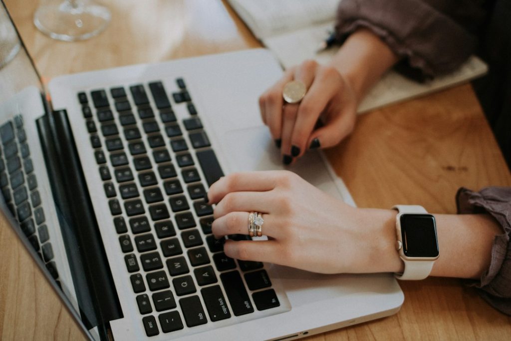 Job seeker planning applications with a laptop and notebook