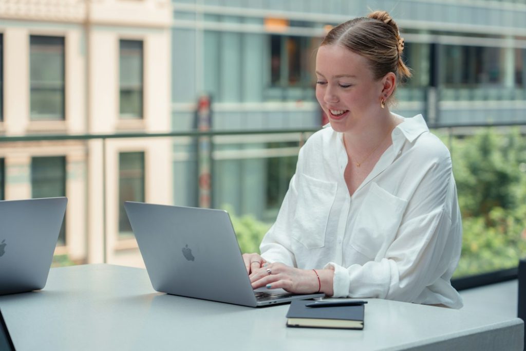 Best AI Certifications in Canada: Costs, Skills and Career Paths Professional comparing AI certification options on a laptop
